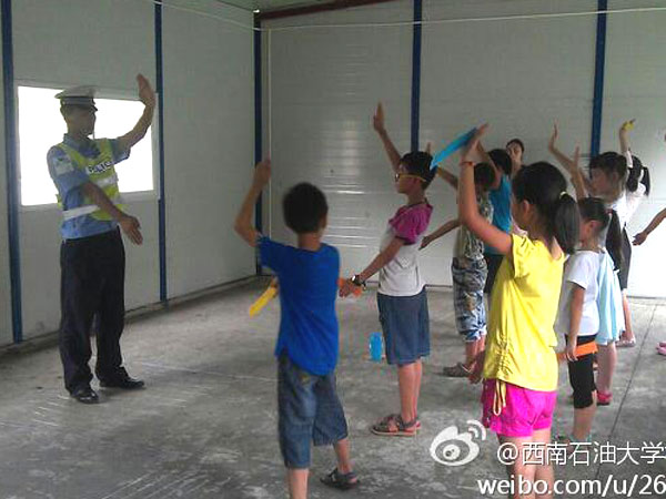 7月24日,西南石油大學校報記者團赴雅安支教志愿隊給孩子們帶來了一堂不一樣的職業(yè)體驗課,其中包括了醫(yī)生,老師,警察,科學家,飲料師五種職業(yè)。隊員們希望,孩子們在各個職業(yè)老師指導下,能對未來懷有理想充滿希望。圖為“交警”正在教導孩子們交通指揮的基礎手勢。